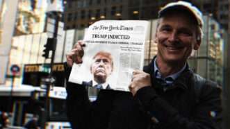 Man holds newspaper in front of Trump Tower | Anthony Behar/Sipa USA/Newscom; Lex Villena