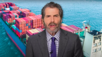 John Stossel is seen in front of a cargo ship | Stossel TV