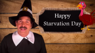 John Stossel dressed in a Pilgrim costume stands next to a sign that says "Happy Starvation Day" | Stossel TV